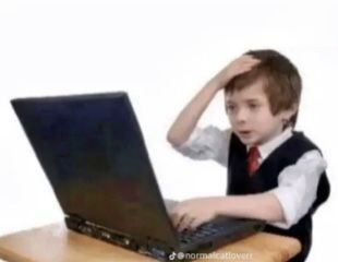 A boy at a laptop with a hand on his head, looking overwhelmed